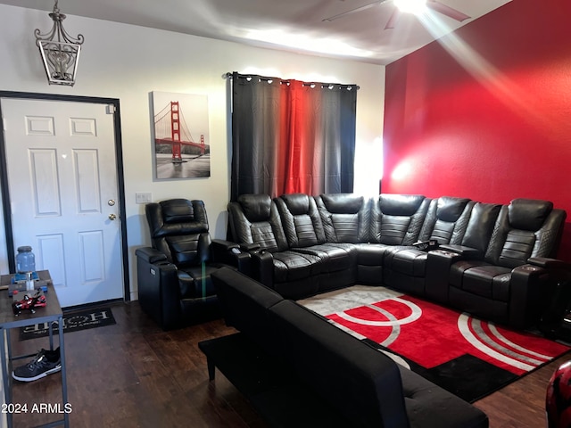 living room featuring ceiling fan and dark wood-type flooring