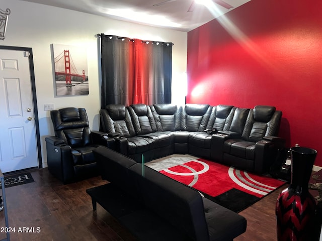 home theater featuring ceiling fan and dark hardwood / wood-style flooring