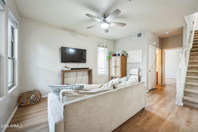 living room featuring ceiling fan and light hardwood / wood-style floors