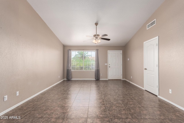 11352 E Dartmouth St, Mesa, AZ 85207 - empty room featuring lofted ceiling, ceiling fan, and dark tile patterned flooring