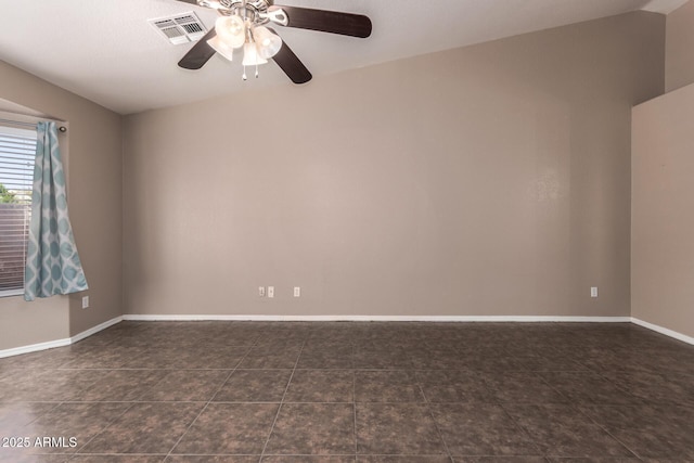 11352 E Dartmouth St, Mesa, AZ 85207 - empty room with a ceiling fan, vaulted ceiling, and dark tile patterned flooring