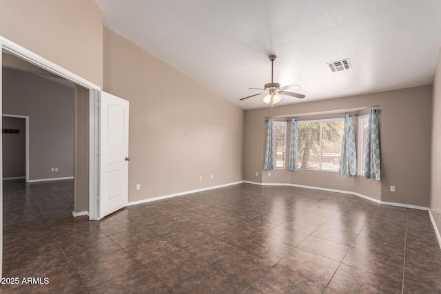 11352 E Dartmouth St, Mesa, AZ 85207 - unfurnished room featuring a ceiling fan, dark tile patterned floors, and vaulted ceiling