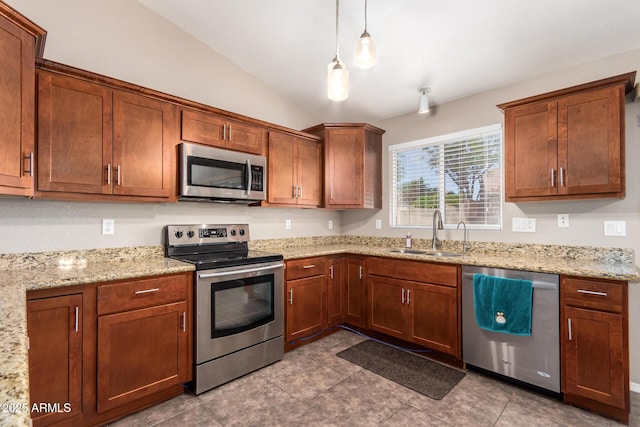 11352 E Dartmouth St, Mesa, AZ 85207 - kitchen featuring appliances with stainless steel finishes, lofted ceiling, pendant lighting, light stone countertops, and brown cabinets