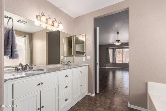 11352 E Dartmouth St, Mesa, AZ 85207 - bathroom with double vanity, healthy amount of natural light, tile patterned flooring, and a bath