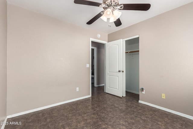 11352 E Dartmouth St, Mesa, AZ 85207 - unfurnished bedroom with a closet, ceiling fan, and dark tile patterned flooring