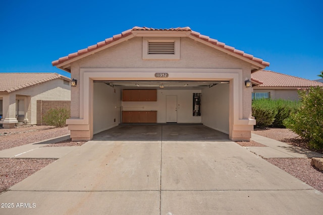 11352 E Dartmouth St, Mesa, AZ 85207 - view of front of property featuring a garage, a tiled roof, driveway, and stucco siding