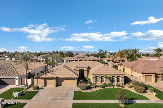 mediterranean / spanish-style home featuring a garage and a front yard