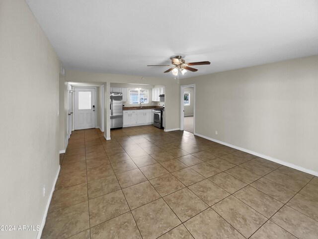 unfurnished bedroom featuring ceiling fan and light colored carpet