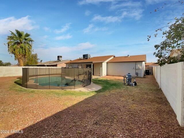 exterior space with a fenced in pool