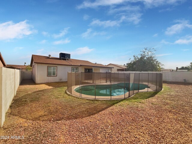 view of pool with central air condition unit