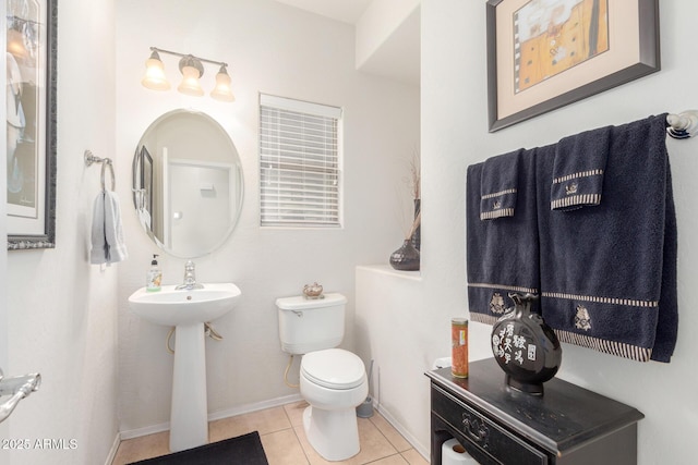 bathroom with tile patterned floors, toilet, and baseboards