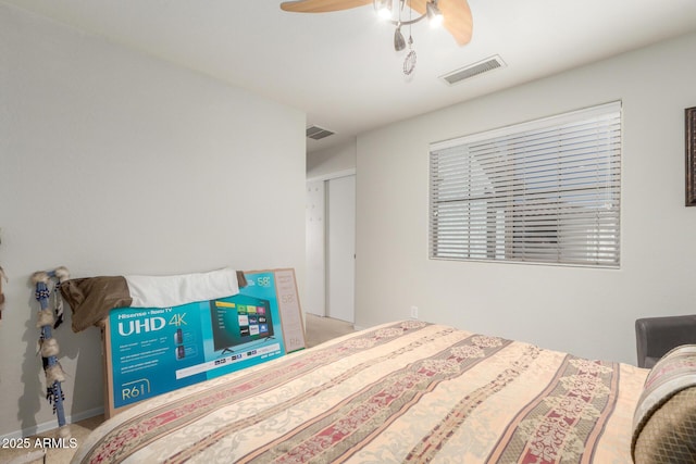 carpeted bedroom featuring visible vents, baseboards, and ceiling fan