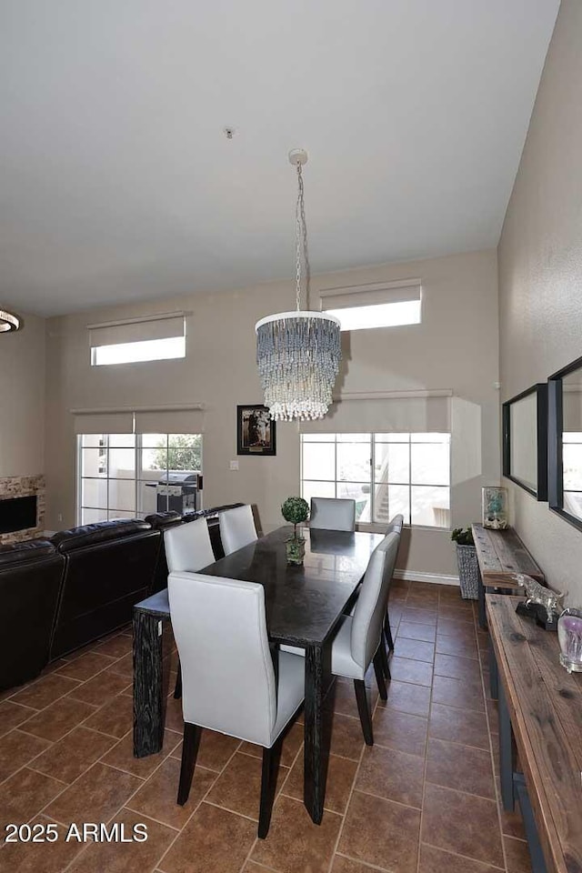 dining room featuring dark tile patterned floors and a chandelier