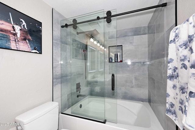 bathroom featuring bath / shower combo with glass door and toilet