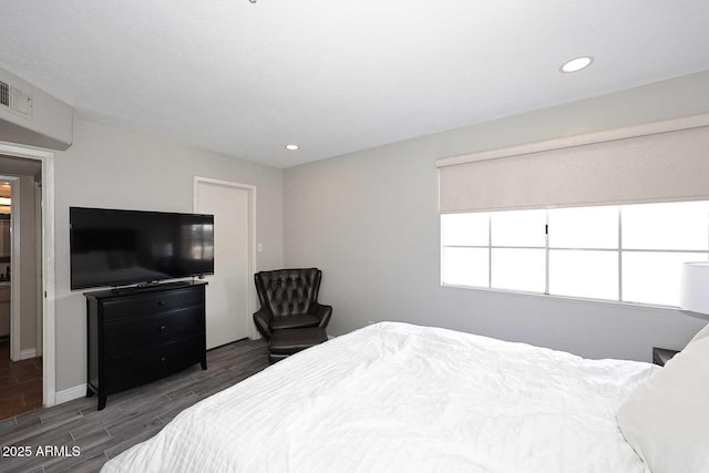 bedroom with recessed lighting, wood finished floors, visible vents, and baseboards