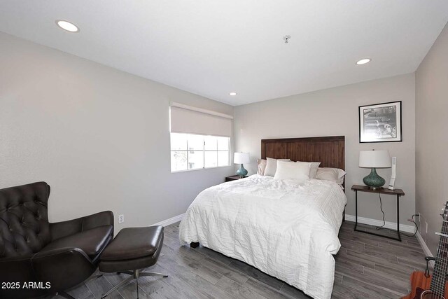 bedroom with dark hardwood / wood-style flooring