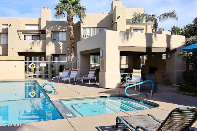 view of pool featuring a community hot tub and a patio