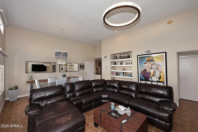 living room with a chandelier and built in shelves