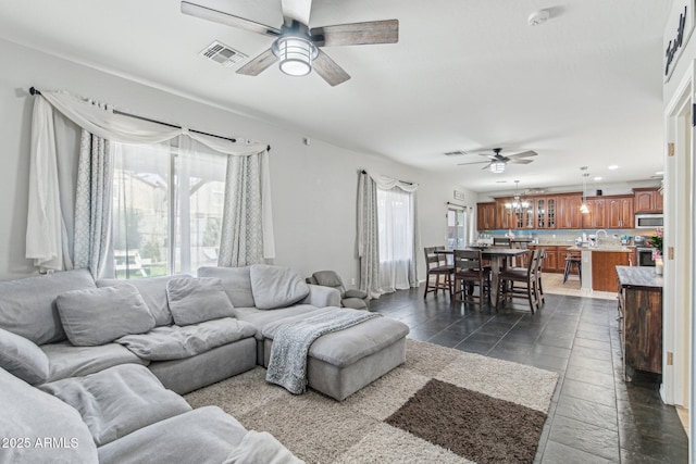 living room featuring ceiling fan, visible vents, and recessed lighting