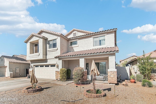 mediterranean / spanish home with a garage, driveway, stone siding, and stucco siding