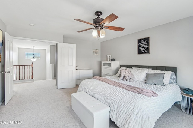 bedroom featuring light carpet and ceiling fan