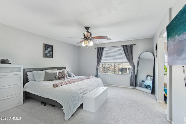 carpeted bedroom with a ceiling fan and baseboards