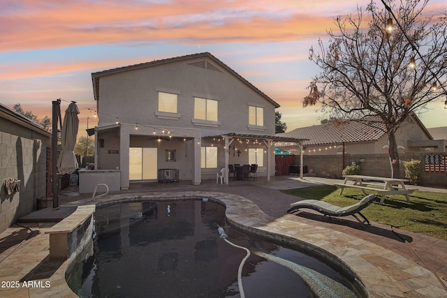 back of property with a patio area, a fenced backyard, and stucco siding