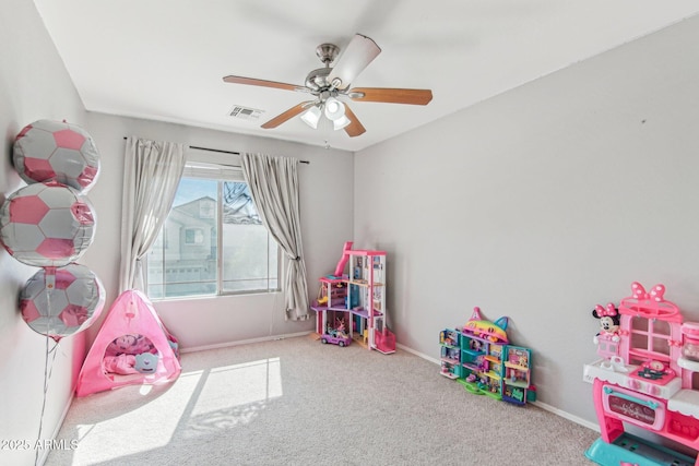 game room with a ceiling fan, carpet, visible vents, and baseboards