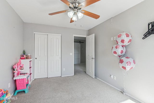 bedroom with carpet, a closet, ceiling fan, and baseboards