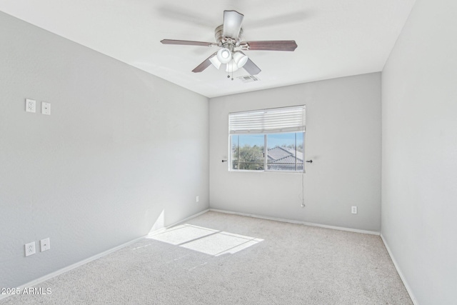 unfurnished room featuring a ceiling fan, light colored carpet, visible vents, and baseboards