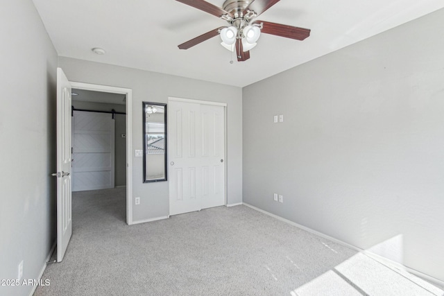 unfurnished bedroom featuring ceiling fan, a closet, carpet flooring, and baseboards