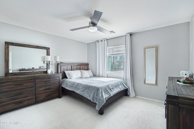 bedroom with light carpet, ceiling fan, and baseboards