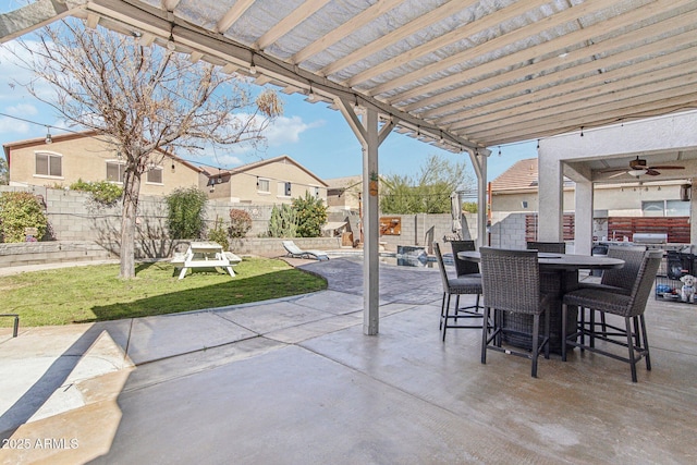 view of patio with a ceiling fan, outdoor dining space, and a fenced backyard