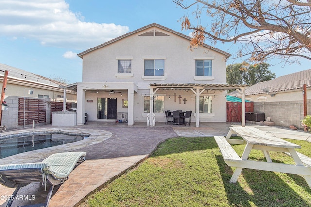 back of property with a patio, a lawn, a fenced backyard, and stucco siding