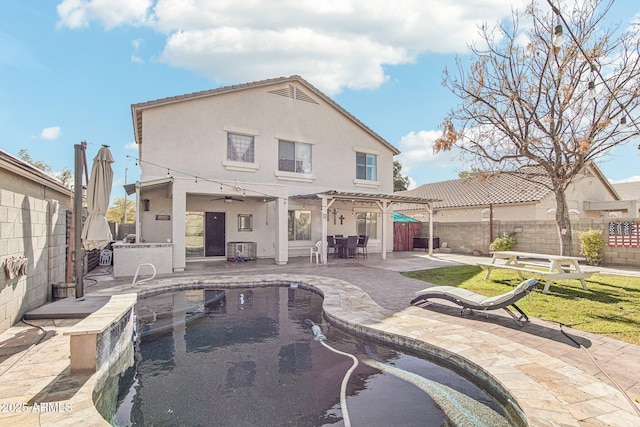 back of property featuring a fenced backyard, a patio, and stucco siding