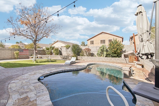 view of swimming pool featuring a patio area, a fenced backyard, and a fenced in pool