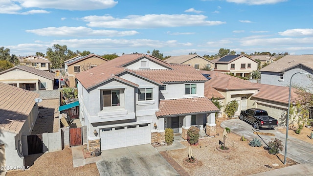 view of front of property featuring a garage, a tiled roof, stone siding, concrete driveway, and a residential view