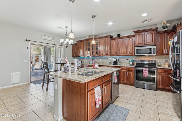 kitchen with light tile patterned floors, visible vents, appliances with stainless steel finishes, and a sink