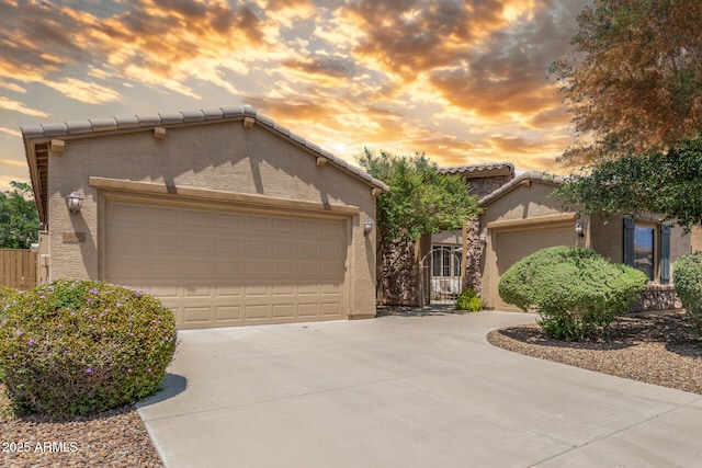 2554 E Honeysuckle Pl, Chandler, AZ 85286 - mediterranean / spanish-style house with driveway, a garage, stucco siding, and a tile roof