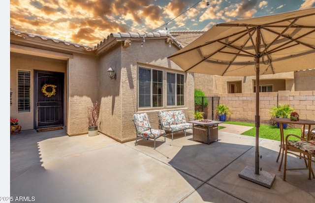 2554 E Honeysuckle Pl, Chandler, AZ 85286 - patio terrace at dusk featuring a fire pit and a patio area