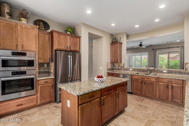 2554 E Honeysuckle Pl, Chandler, AZ 85286 - kitchen featuring stainless steel appliances, decorative backsplash, recessed lighting, a kitchen island, and brown cabinets
