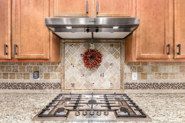 2554 E Honeysuckle Pl, Chandler, AZ 85286 - kitchen featuring stainless steel gas cooktop, backsplash, ventilation hood, and light stone counters