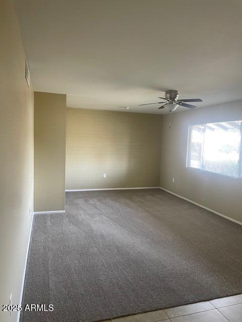 unfurnished room featuring carpet floors and ceiling fan