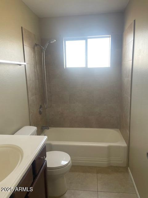 full bathroom featuring tiled shower / bath, vanity, tile patterned floors, and toilet