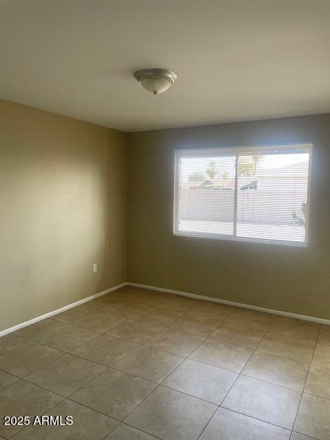 spare room featuring light tile patterned floors