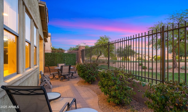view of patio featuring outdoor dining space and fence