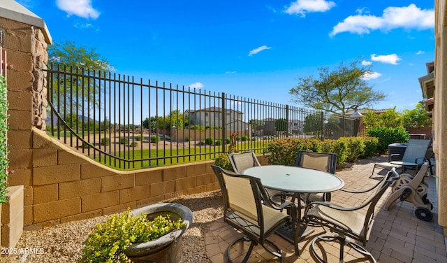 view of patio featuring fence and outdoor dining space