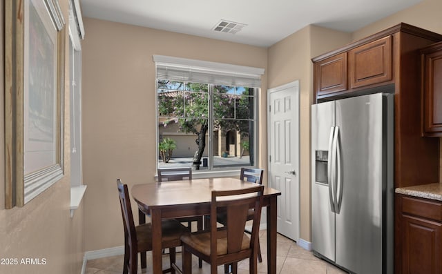 dining room featuring light tile patterned floors and baseboards