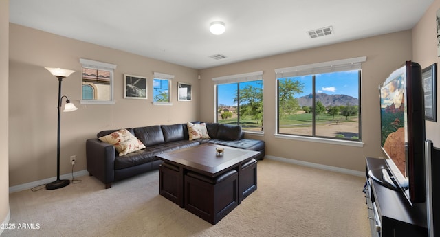 living room with light carpet and baseboards
