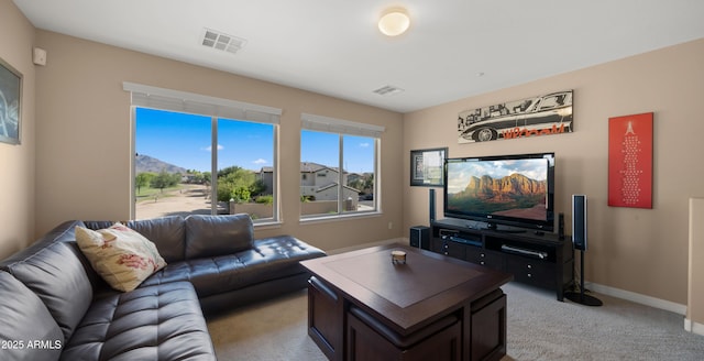 living area with light carpet and baseboards